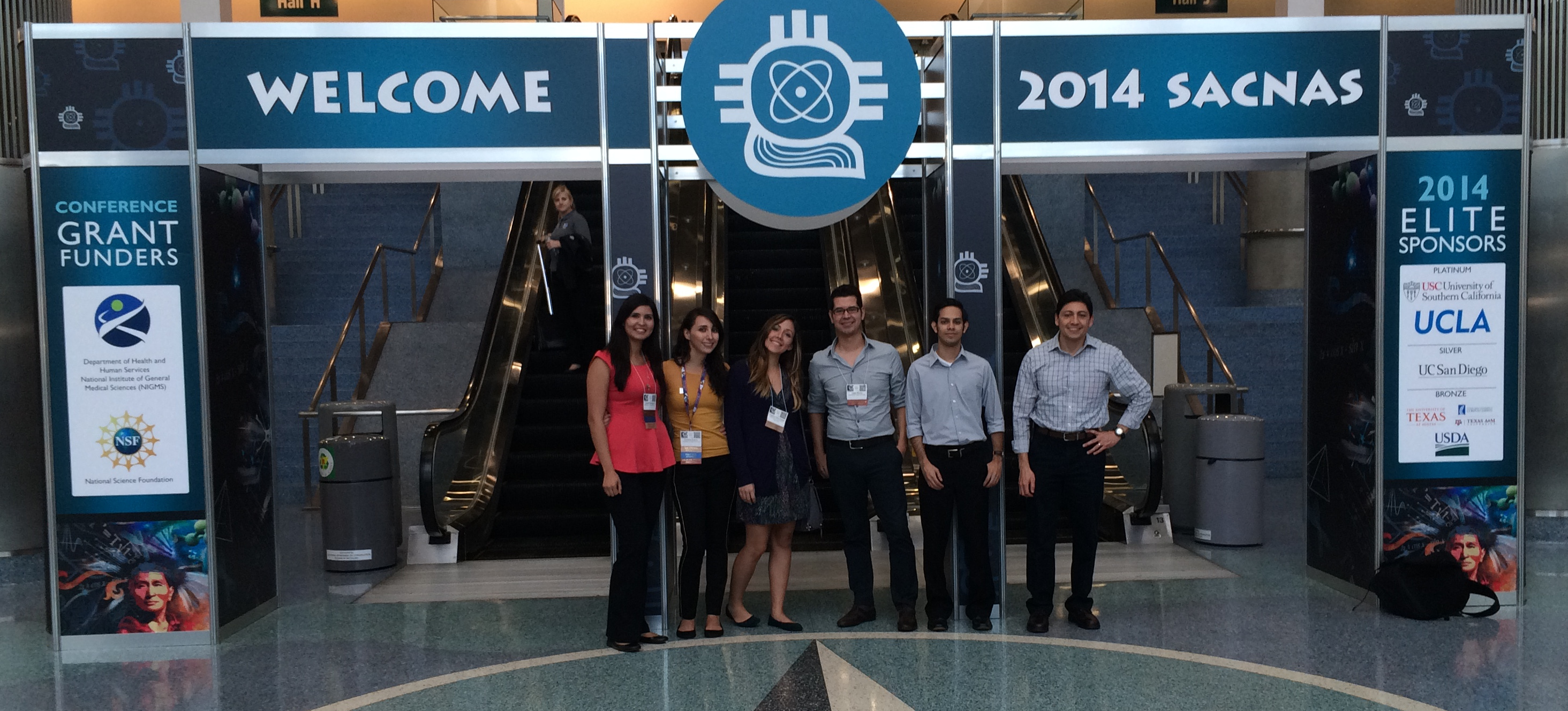 Clemente Aguilar, NIMBioS postdoctoral fellow (right) with conference participants at SACNAS, including Carolina Guerra (gold shirt) who was a NIMBioS visiting graduate fellow from June-August 2014.